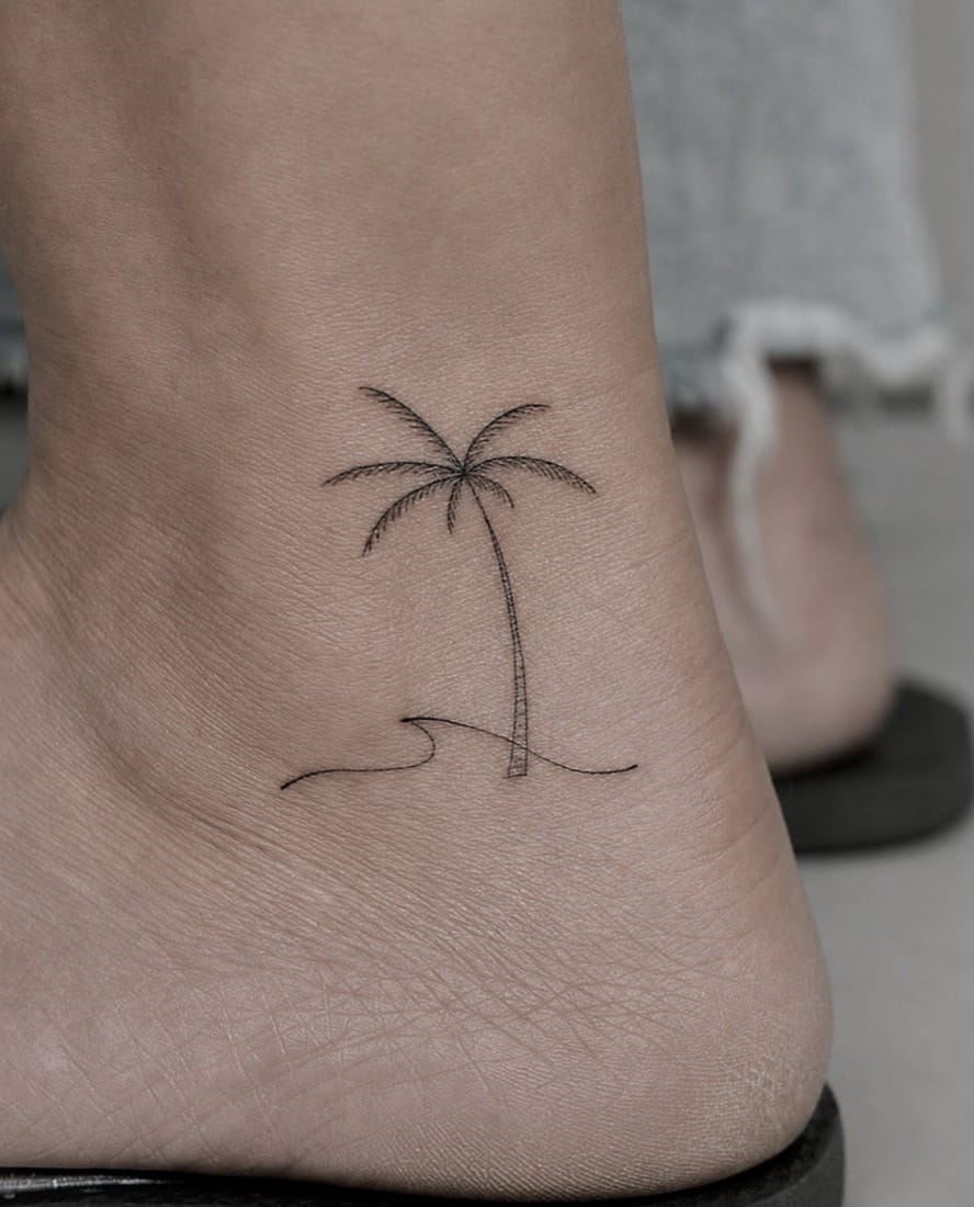 Fine line palm tree and wave tattoo by an Essex Fine Line Tattoo Academy student